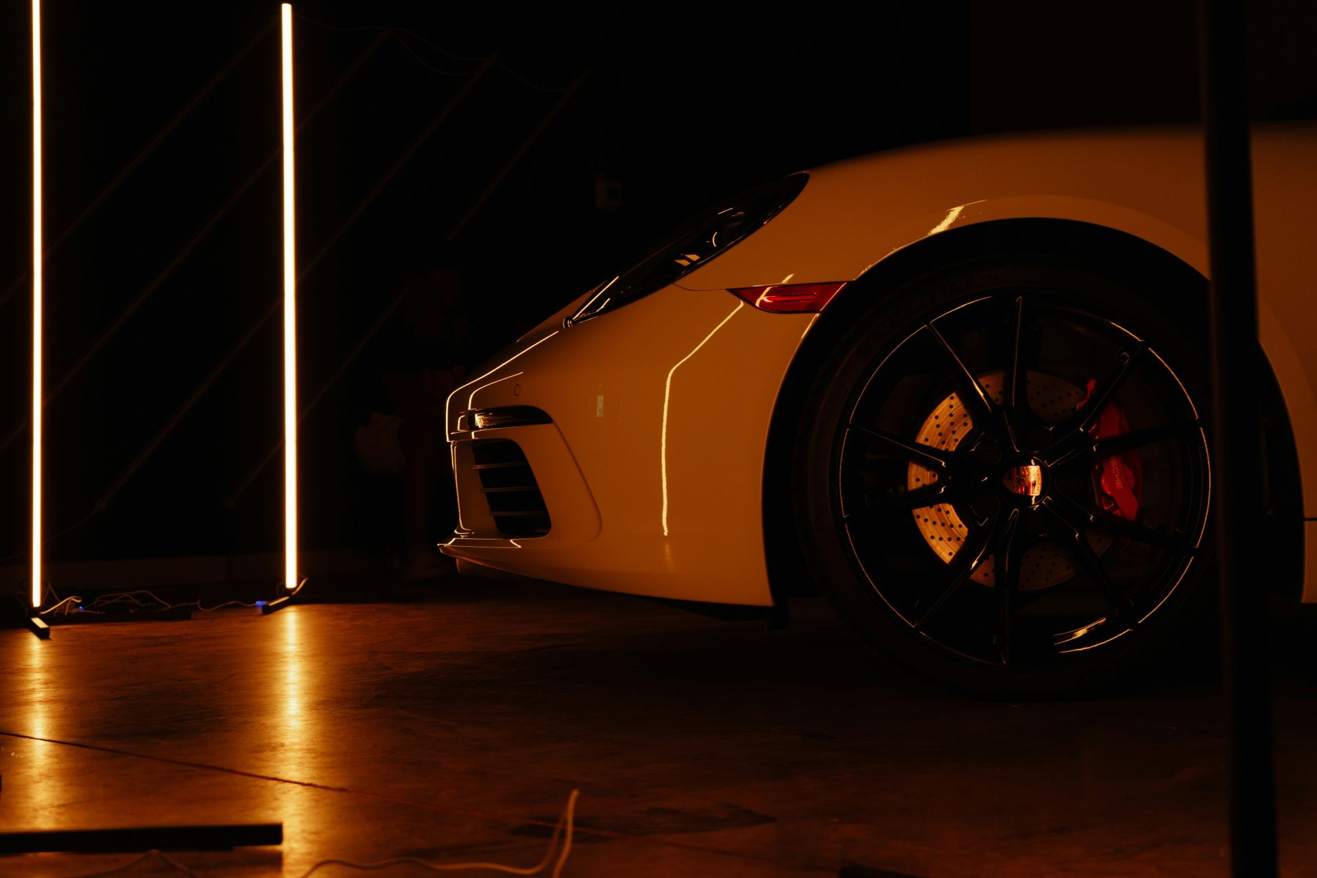 A yellow sports car parked in a garage